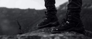 Hiker wearing boots standing on rock formation