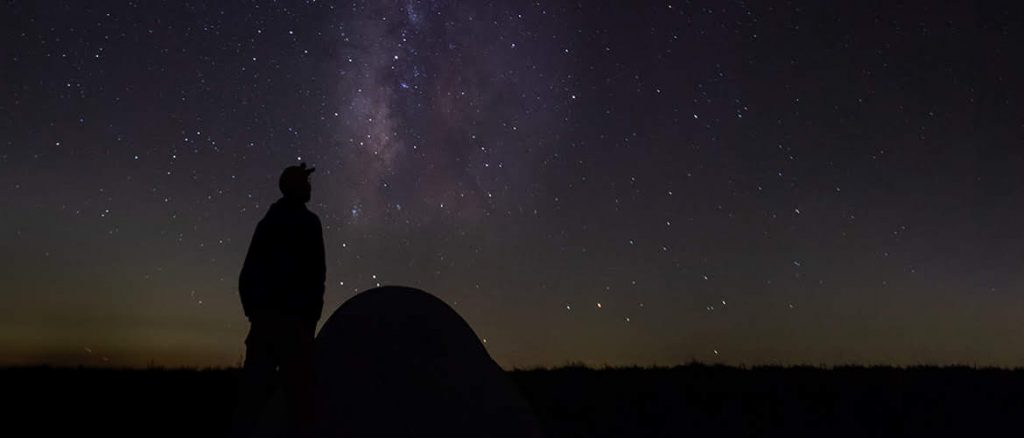 looking at the clear stars in the night while camping away from the city.