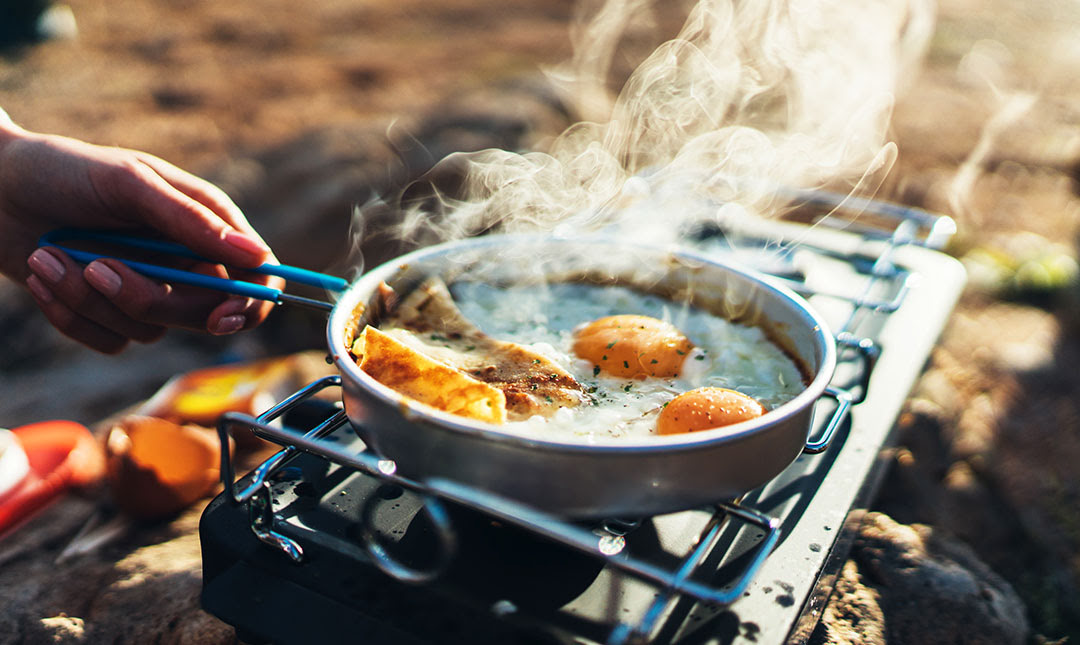camping breakfast cooking in a pan